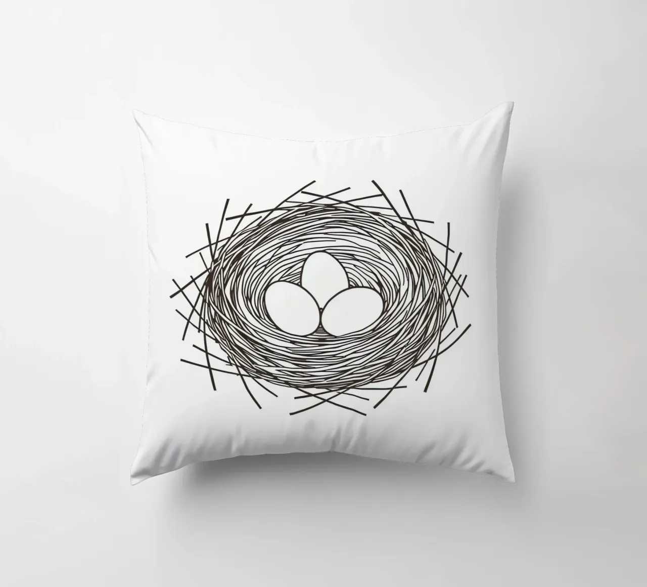Nest containing three eggs depicted with line art decorative cushion by DesignDoodle