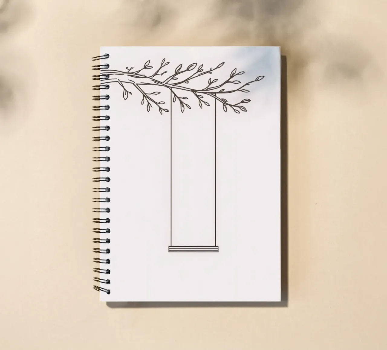 Empty swing hanging from a tree branch in a minimalist art spiral notebook by DesignDoodle