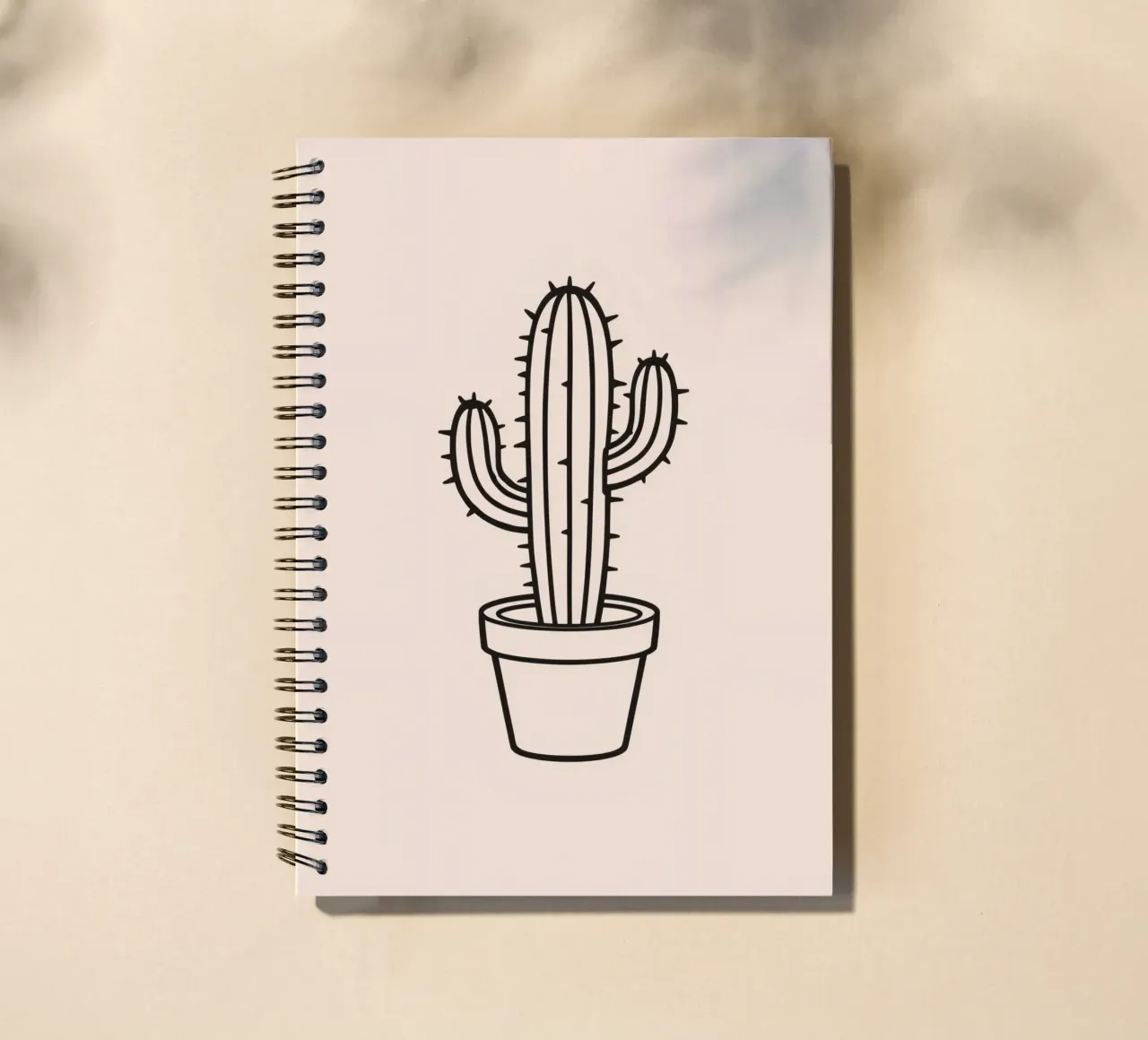 Cactus in a simple pot displayed against a plain background spiral notebook by DesignDoodle