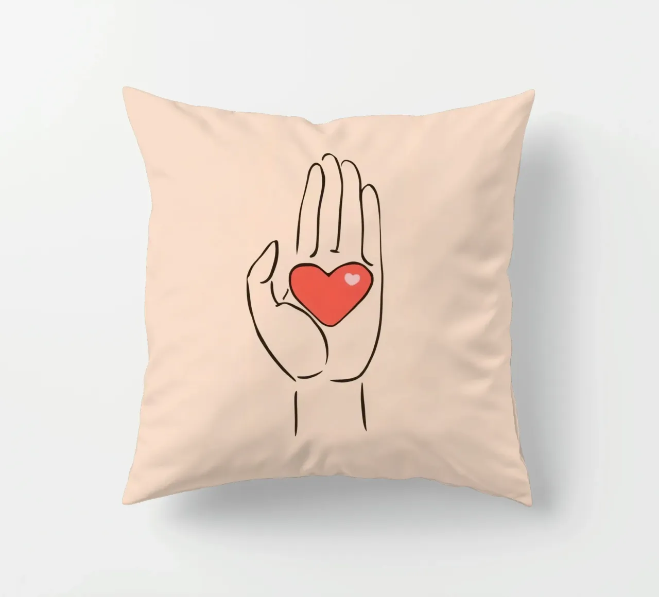 Mano che regge un cuore che rappresenta amore e gentilezza cuscino da DesignDoodle