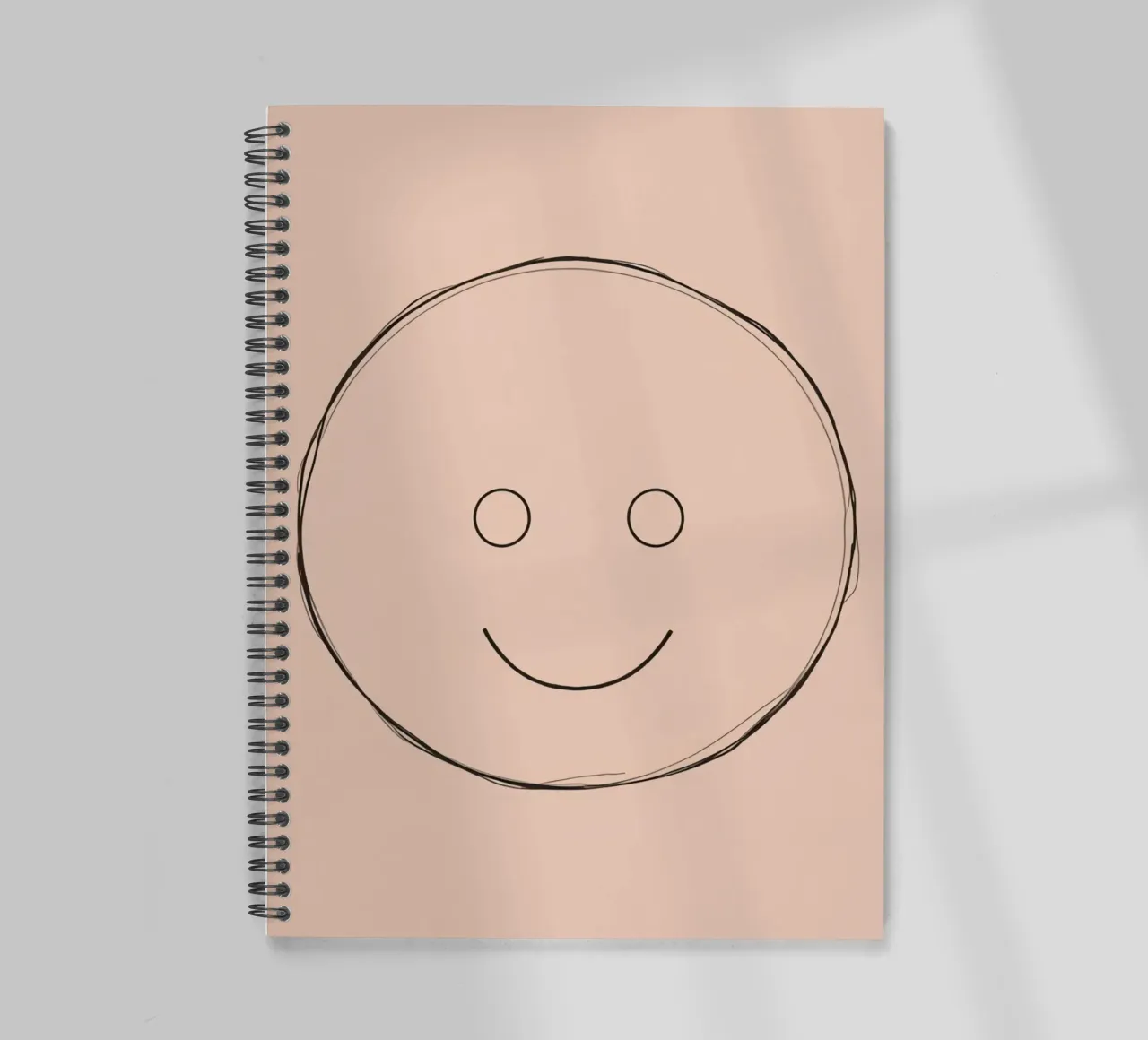 Simple smiley face illustration on a plain peach background spiral notebook by DesignDoodle