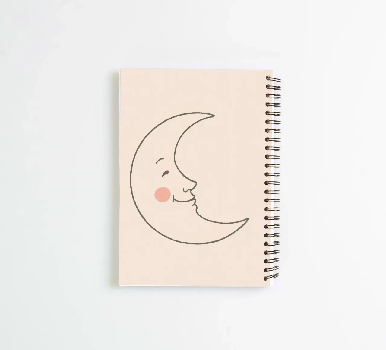 Happy moon illustration with a smiling face on a light art spiral notebook by DesignDoodle