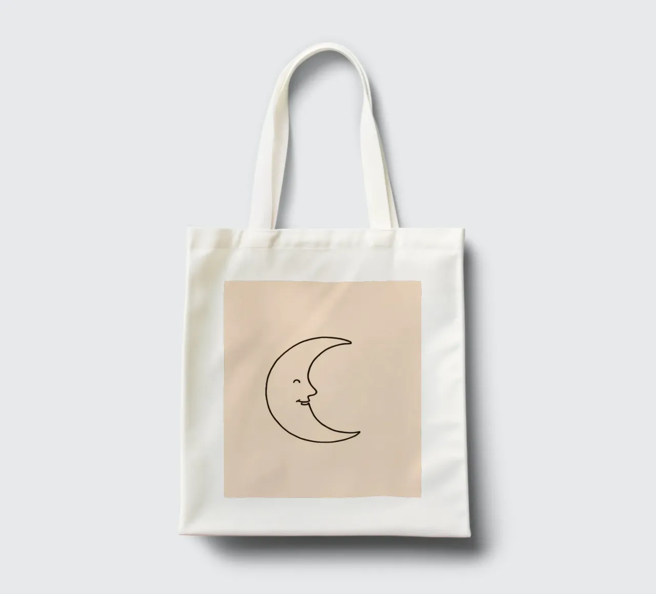 Crescent moon with a smiling face on a soft background tote bag by DesignDoodle
