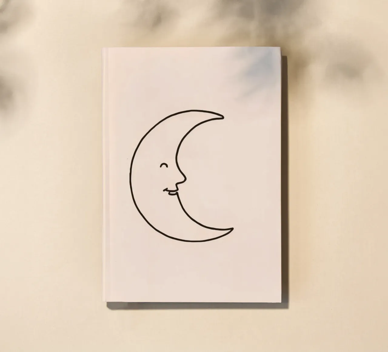 Crescent moon with a smiling face on a soft background notebook by DesignDoodle