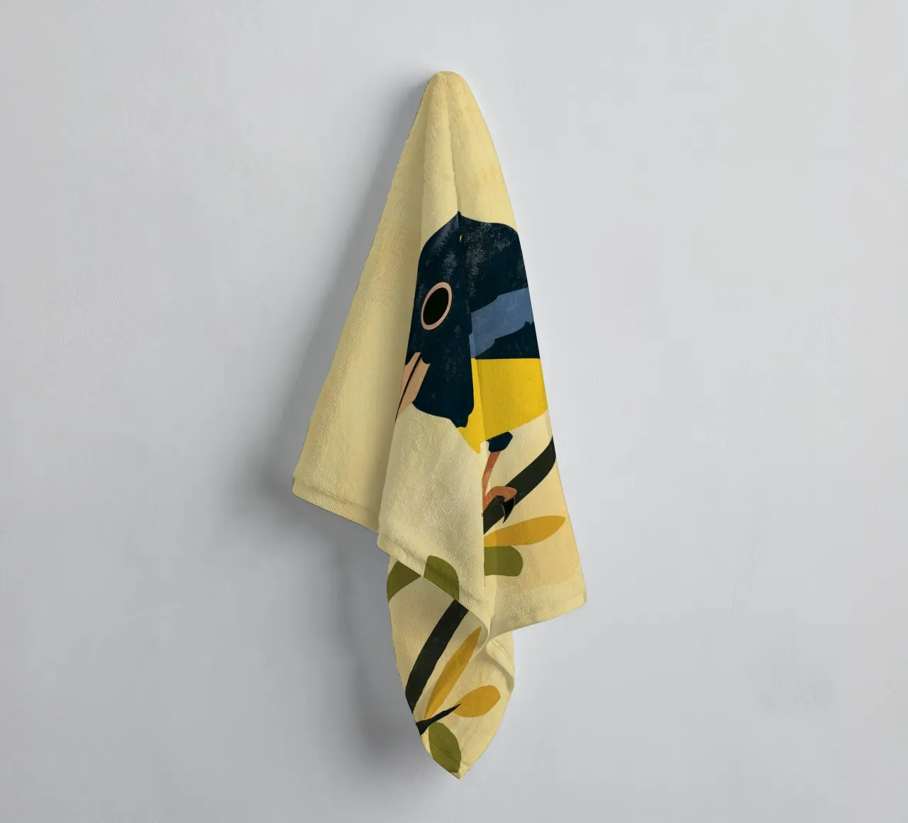 Yellow and blue bird perched on branch with leaves towel by DesignDoodle