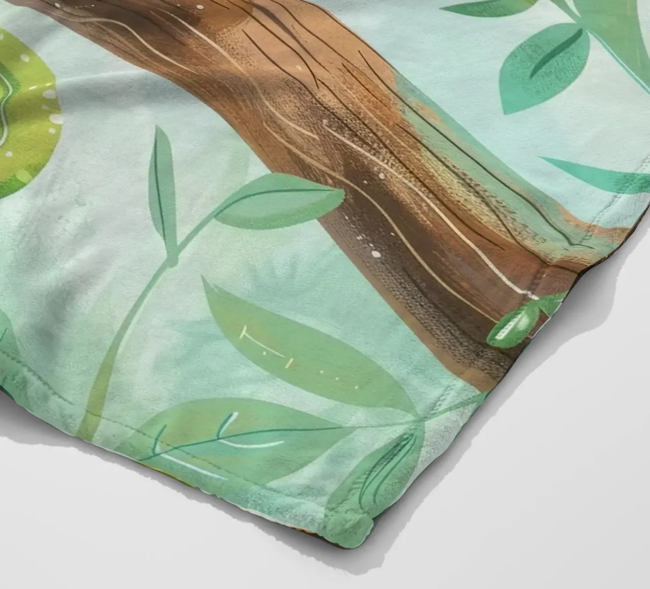 Cheerful green lizard resting on a branch amid leafy fleece blanket by DesignDoodle