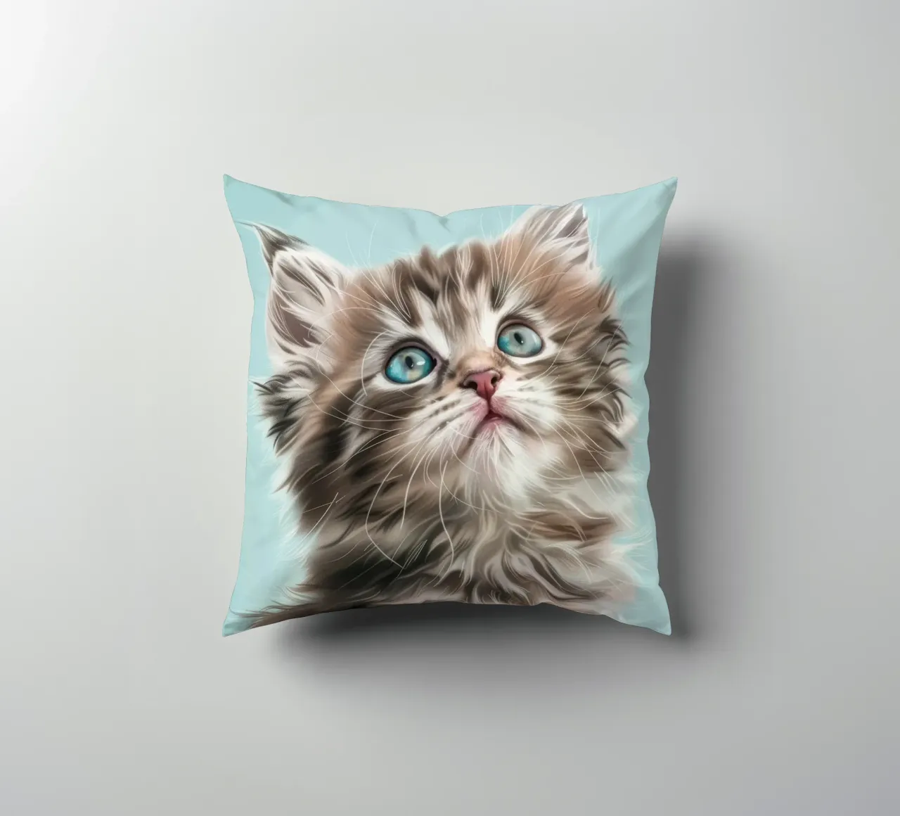Adorable fluffy kitten gazing upward with striking blue eyes decorative cushion by DesignDoodle