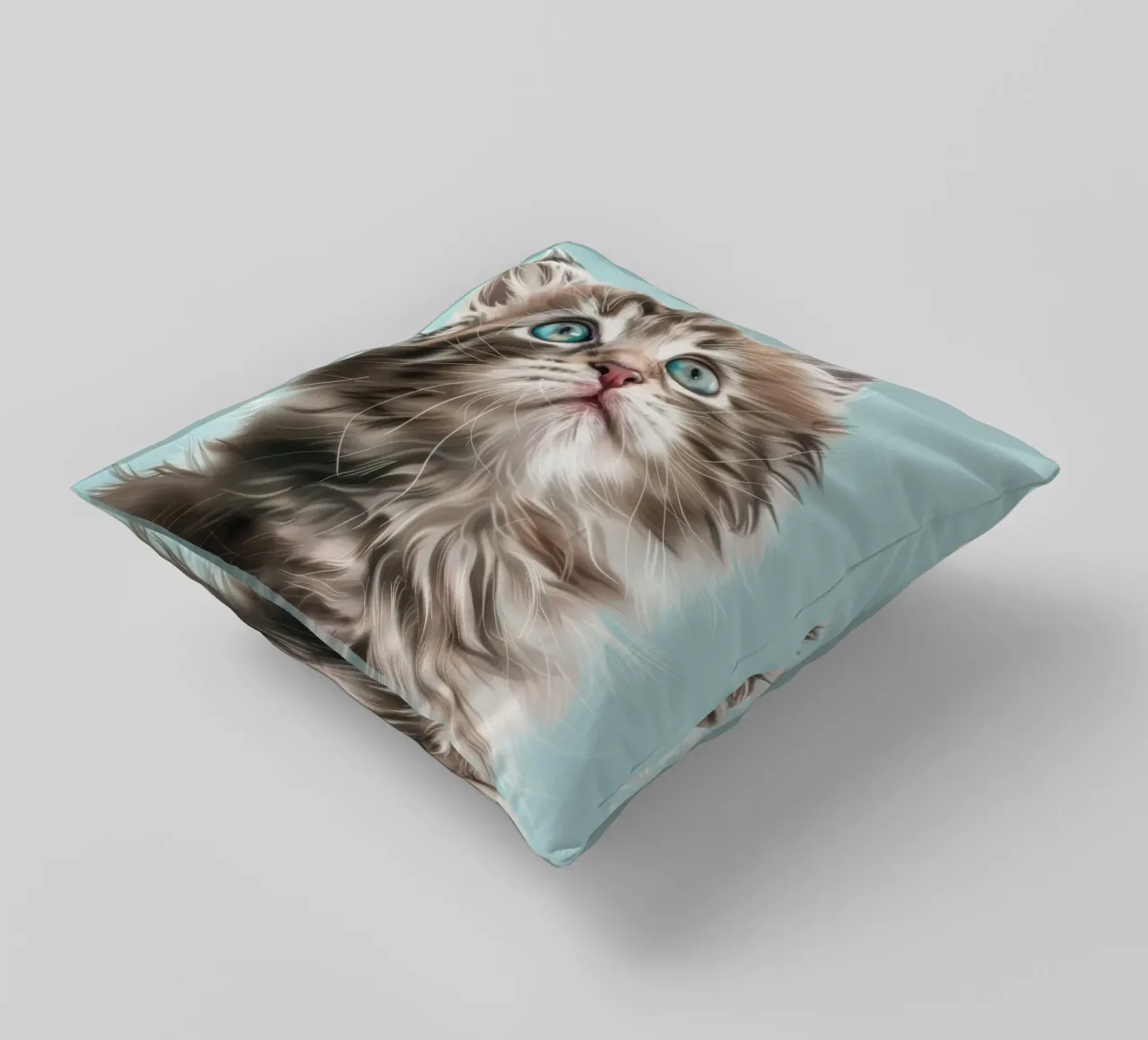Adorable fluffy kitten gazing upward with striking blue eyes decorative cushion by DesignDoodle