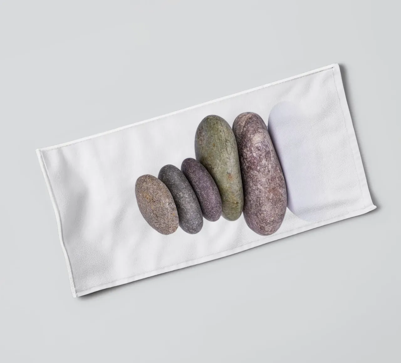 Stone stack in balance against a white background towel by Bilderwelt - Kunst für die Wand