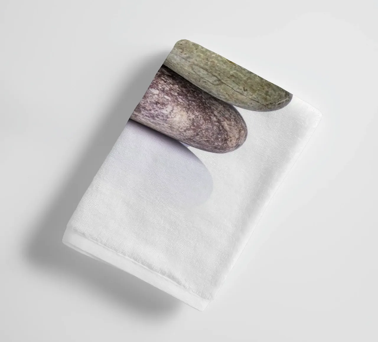 Stone stack in balance against a white background towel by Bilderwelt - Kunst für die Wand