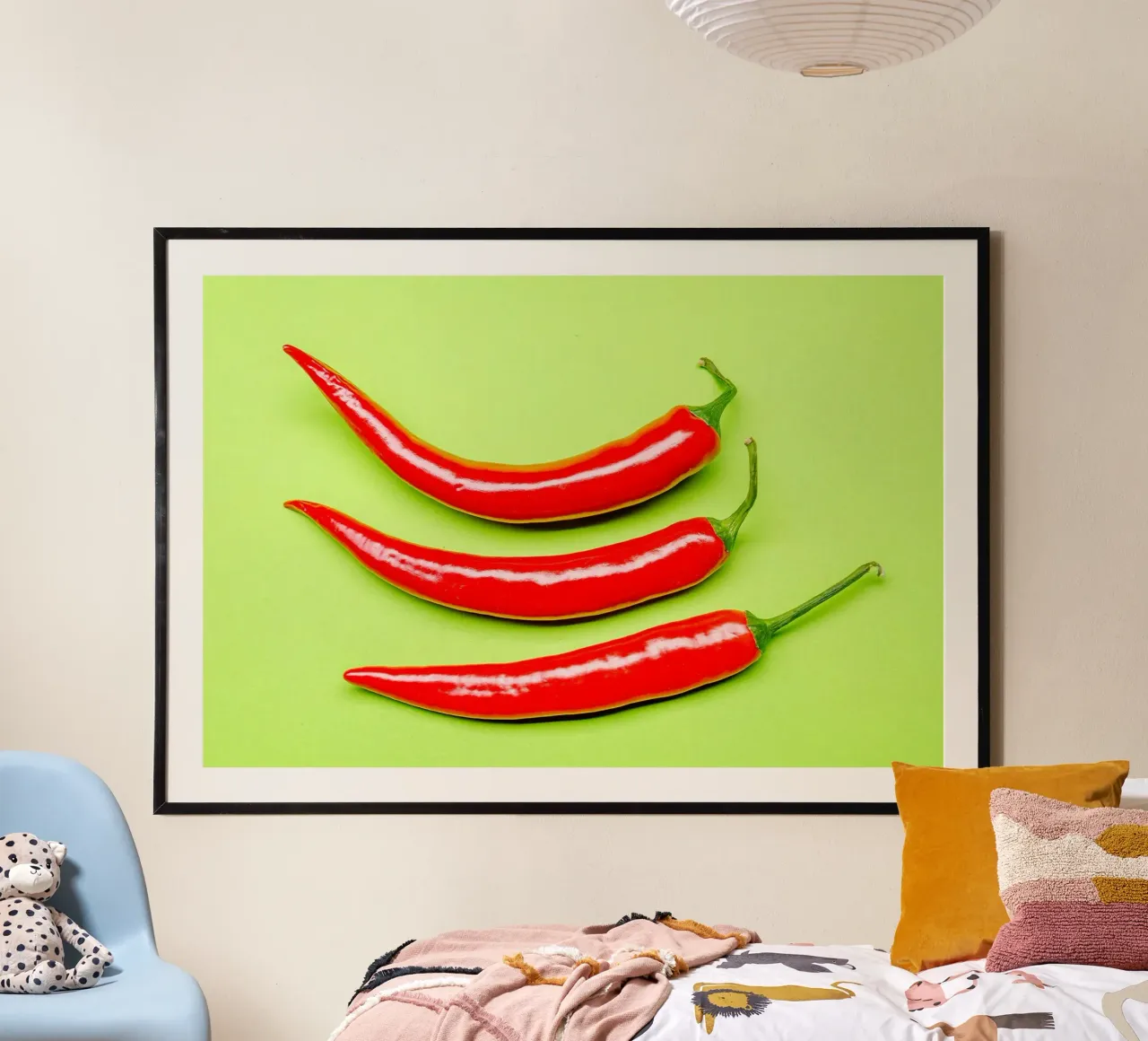 Three red chilli peppers on a green surface poster with aluminum frame by Bilderwelt - Kunst für die Wand