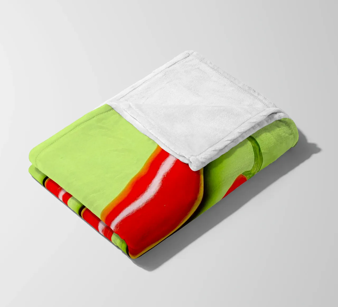 Three red chilli peppers on a green surface fleece blanket by Bilderwelt - Kunst für die Wand