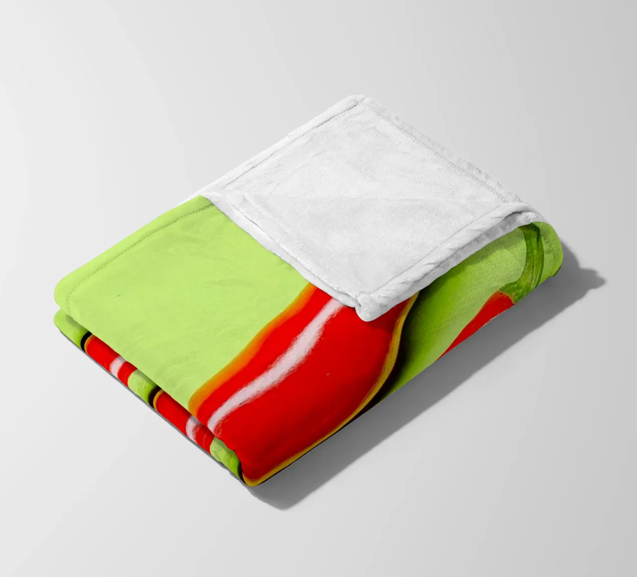 Three red chilli peppers on a green surface fleece blanket by Bilderwelt - Kunst für die Wand