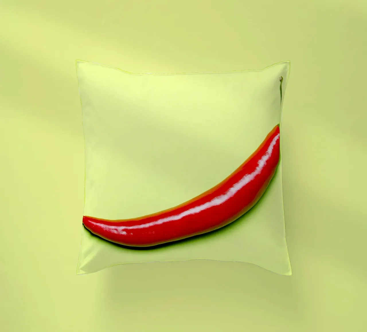 Red chilli pepper on a green background decorative cushion by Bilderwelt - Kunst für die Wand