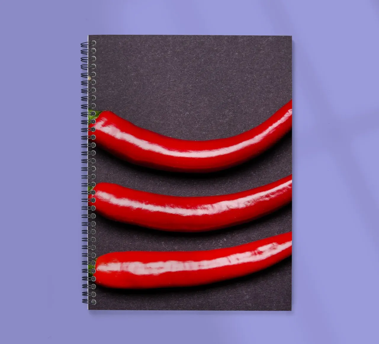 Three chilli peppers on a black background spiral notebook by Bilderwelt - Kunst für die Wand
