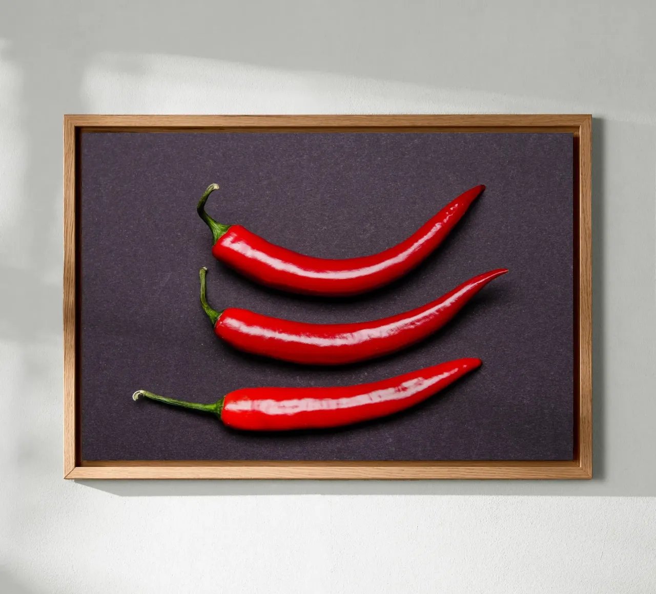Three chilli peppers on a black background canvas with Floater frame by Bilderwelt - Kunst für die Wand