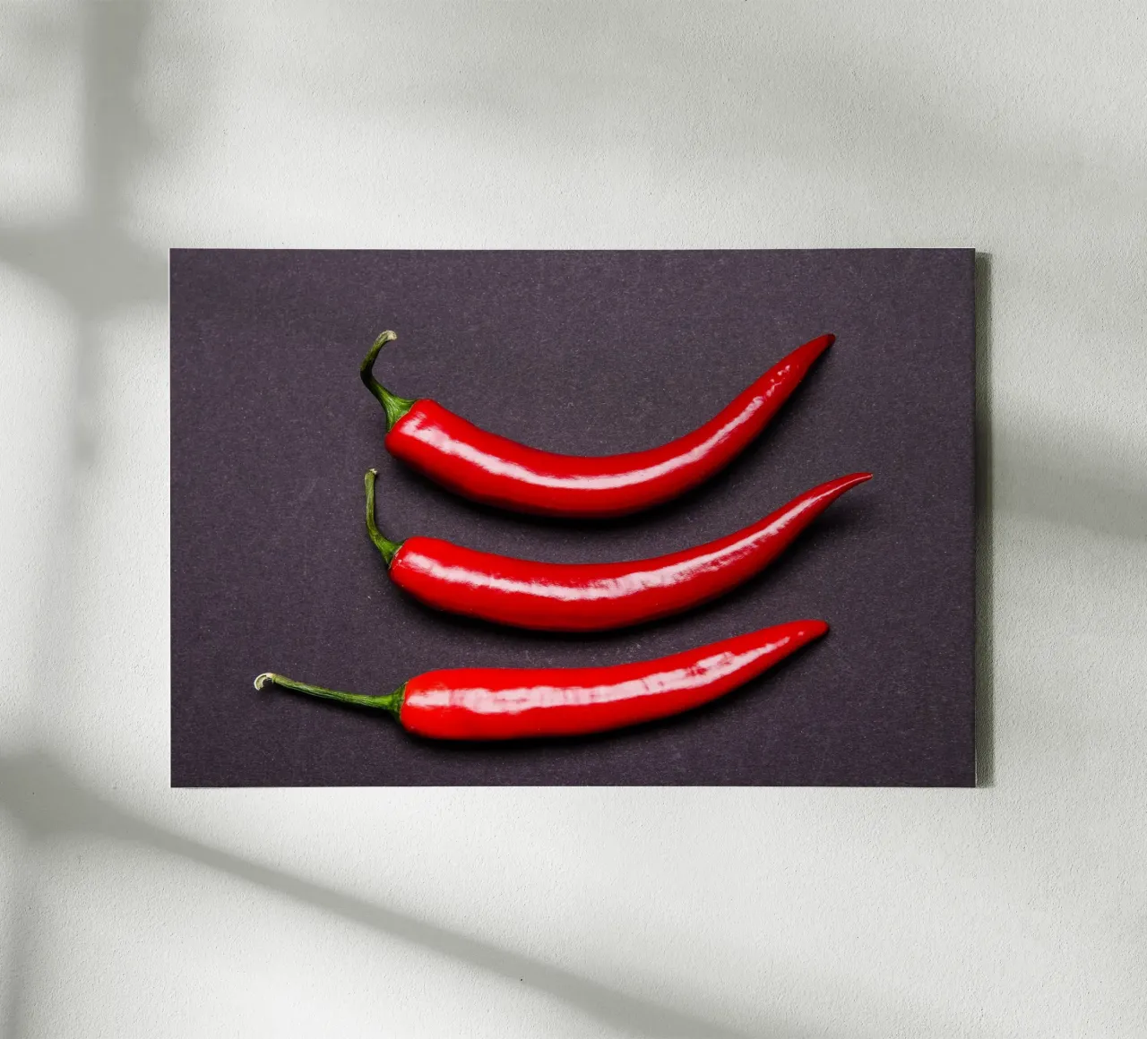 Three chilli peppers on a black background canvas with Floater frame by Bilderwelt - Kunst für die Wand