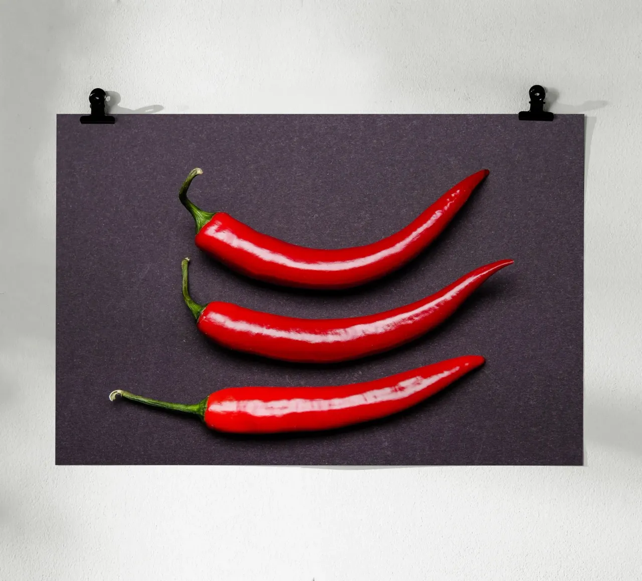 Three chilli peppers on a black background hahnemühle by Bilderwelt - Kunst für die Wand