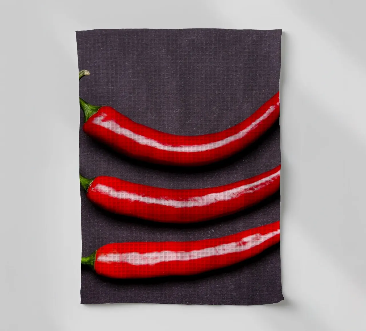 Three chilli peppers on a black background tea towel by Bilderwelt - Kunst für die Wand