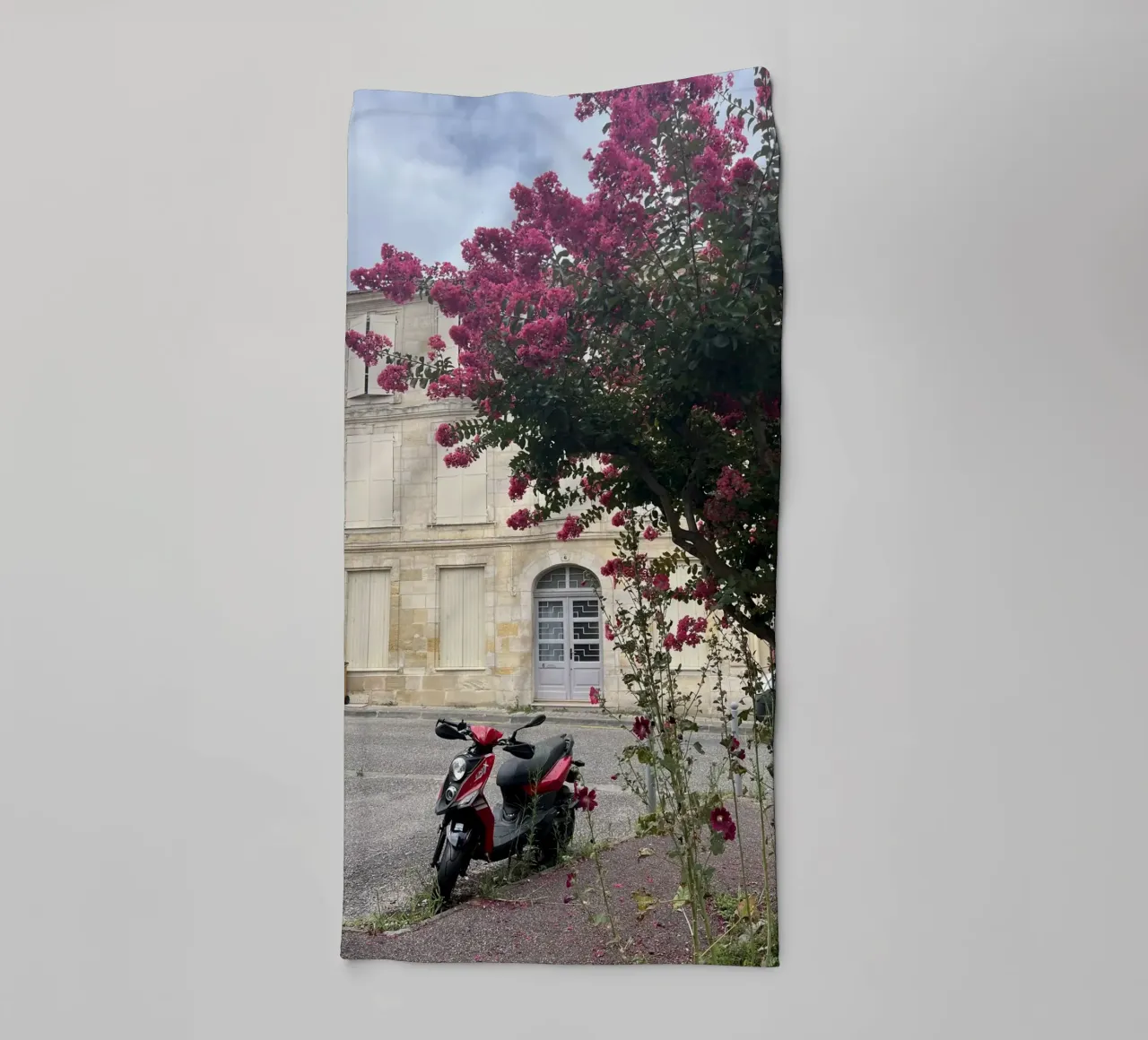Motorbike in front of a beige house with a flowering shrub in France towel by Sous le ciel