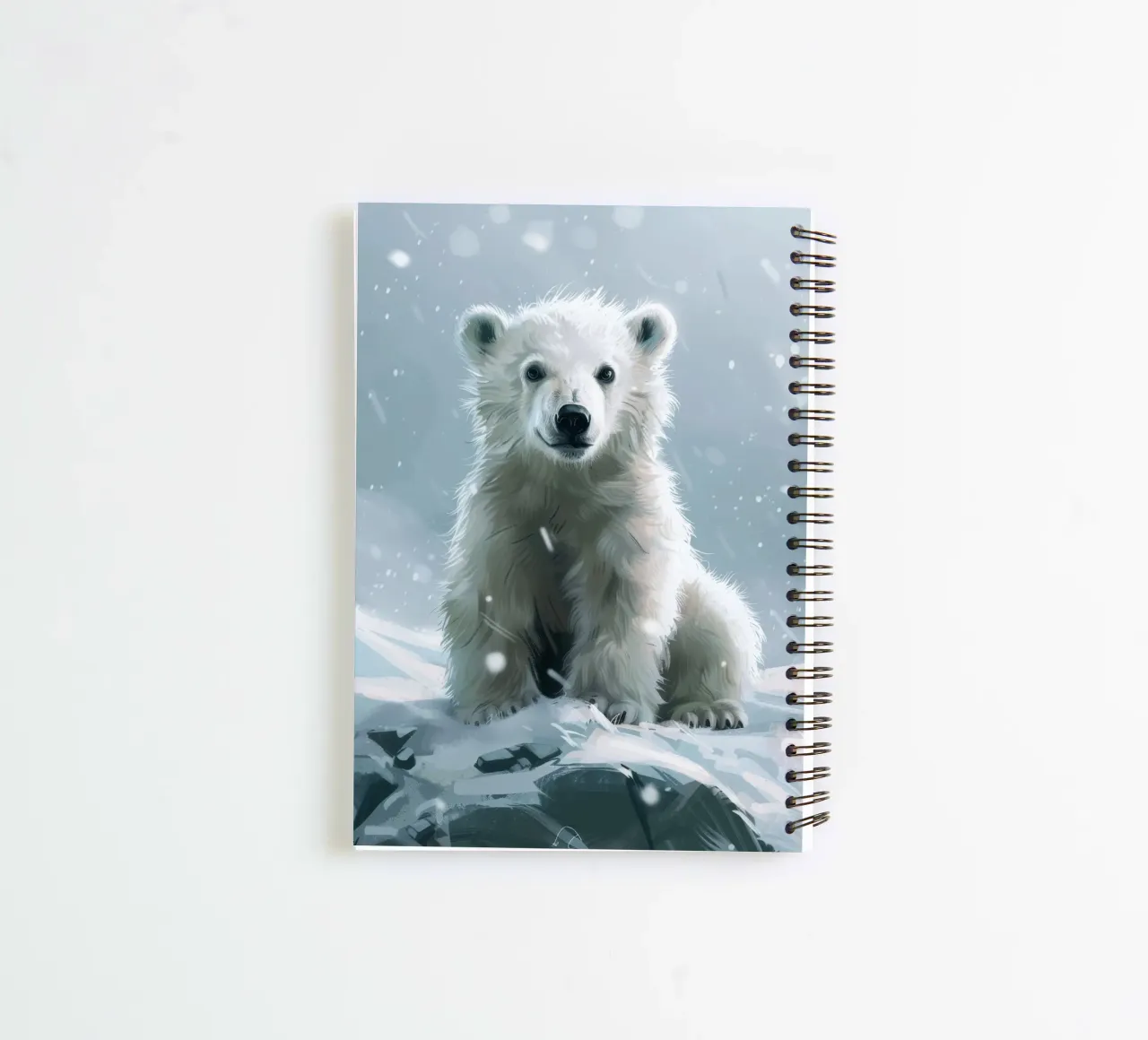 Polar bear cub sitting on snowy landscape with falling snow spiral notebook by DesignDoodle