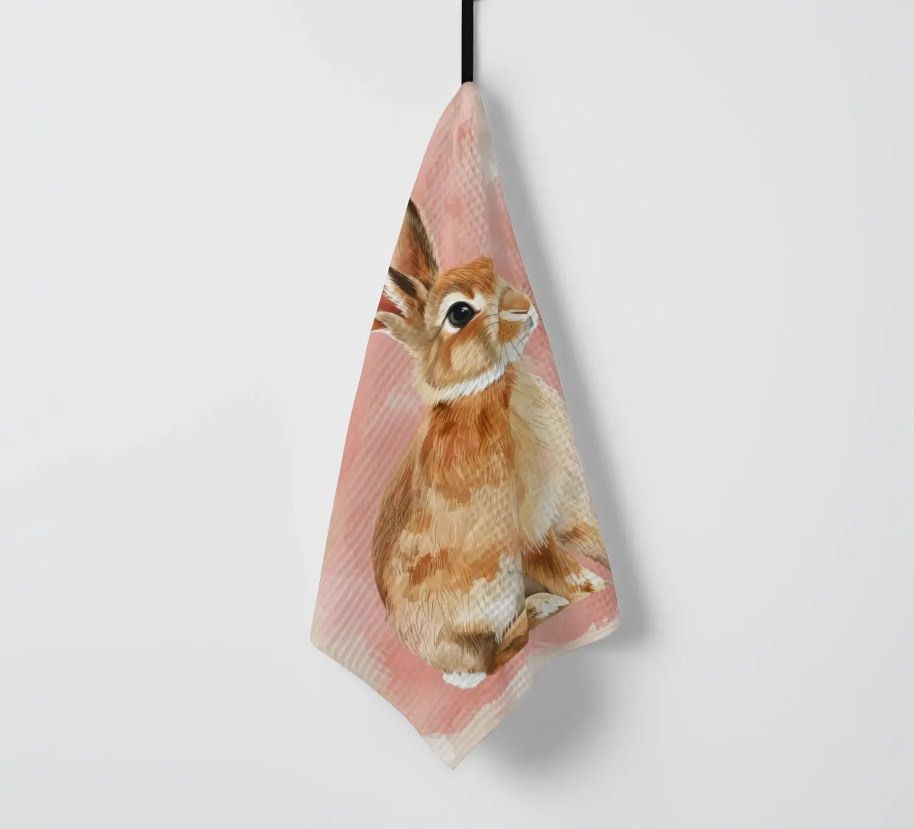 Charmante représentation d'un lapin assis sur un fond pastel. torchon de DesignDoodle