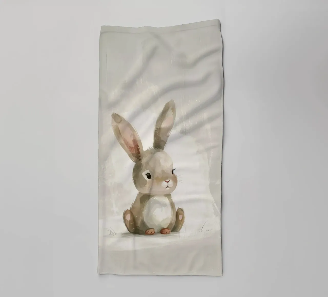 Cute brown bunny sitting on a soft background towel by DesignDoodle