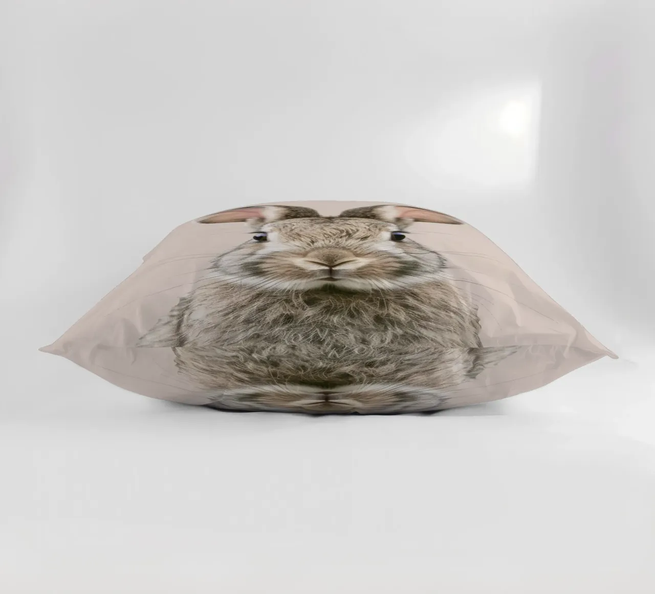 Fluffy rabbit with expressive eyes against a neutral art decorative cushion by DesignDoodle