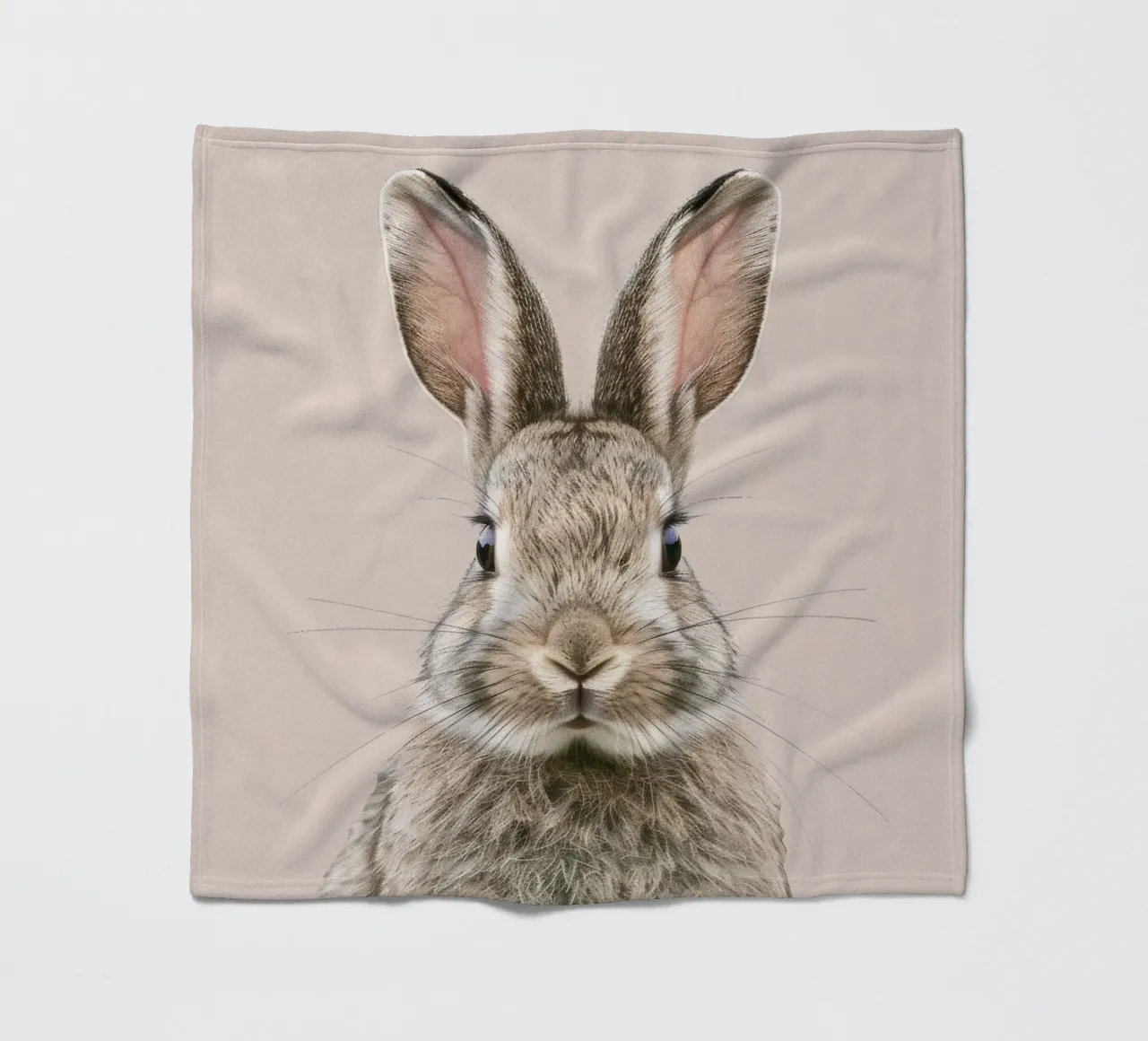 Fluffy rabbit with expressive eyes against a neutral art fleece blanket by DesignDoodle