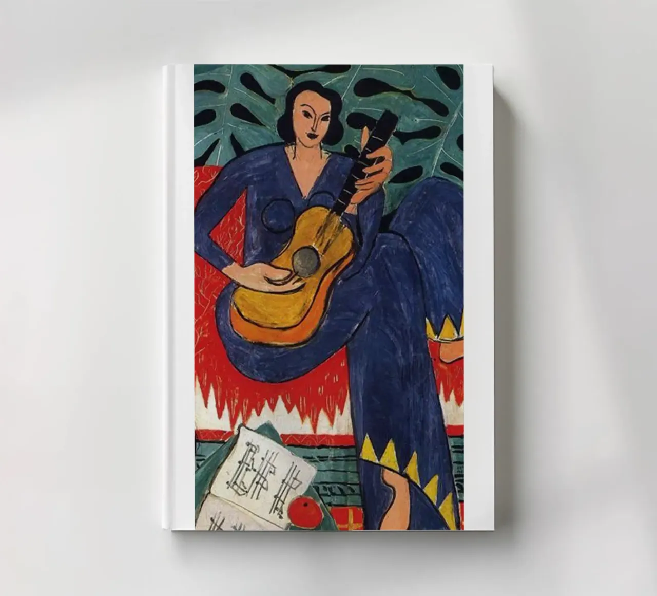 a woman playing guitar notebook by sazkia art