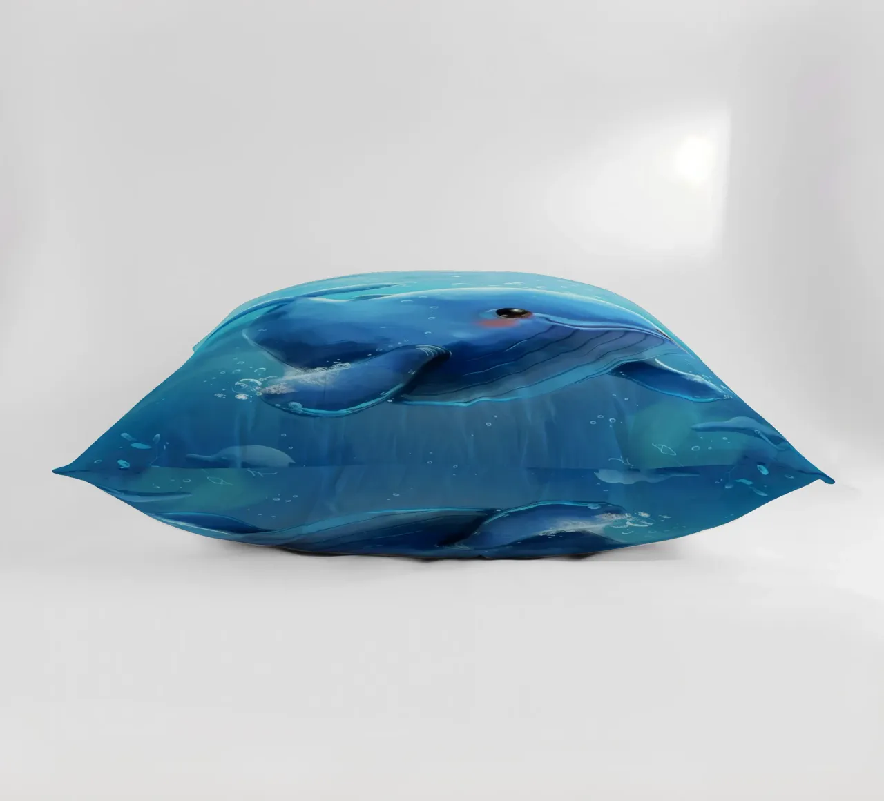 Affascinante balenottera azzurra che nuota giocosamente in un luminoso sottofondo cuscino da DesignDoodle