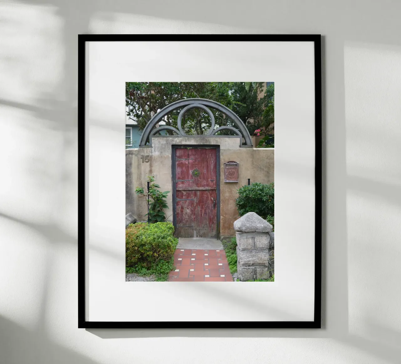 Un affascinante muro di pietra e una porta di legno a St. Augustine poster con telaio in legno da byrieneke