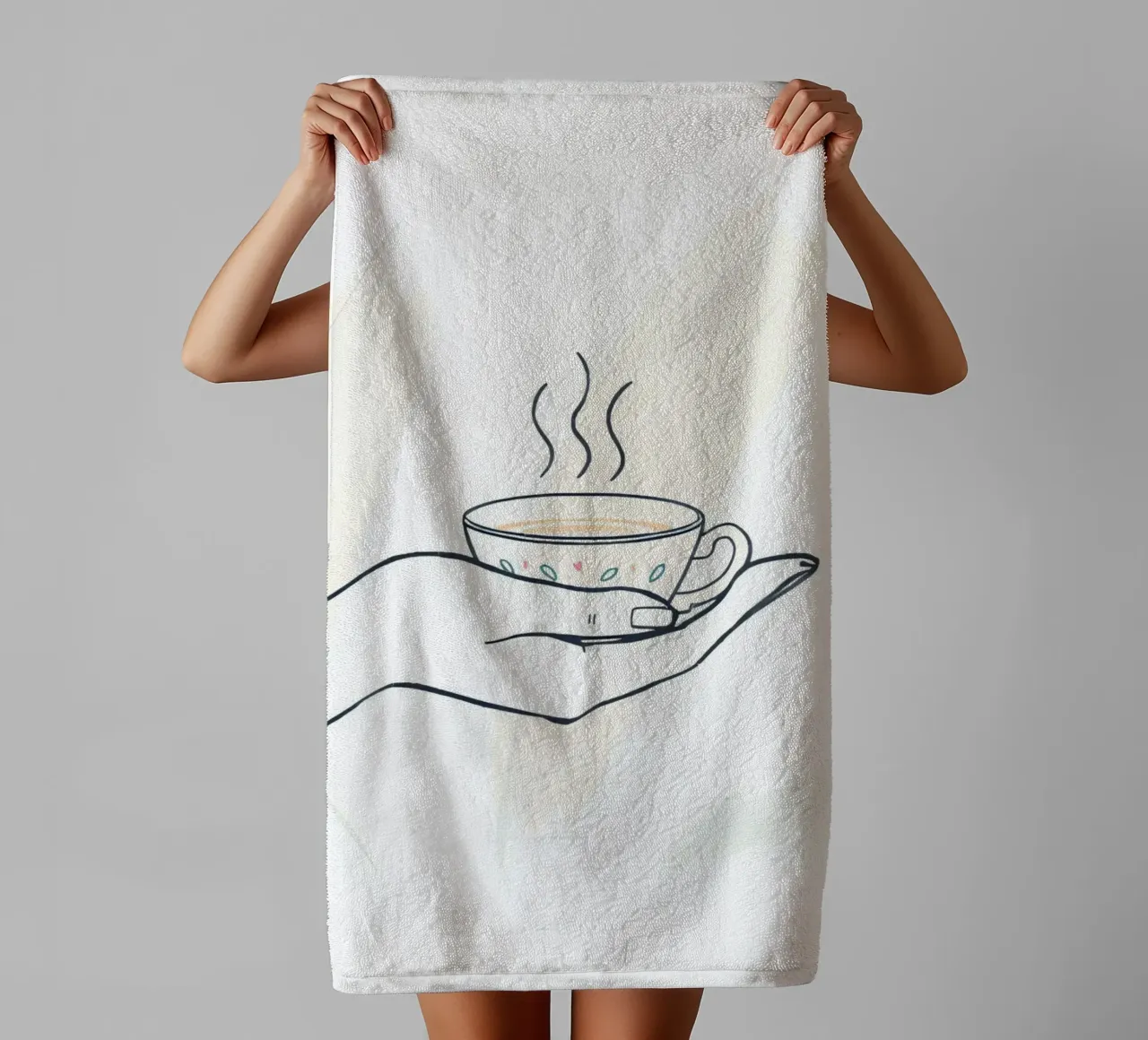 Hand holding a steaming cup of tea against a soft background towel by DesignDoodle