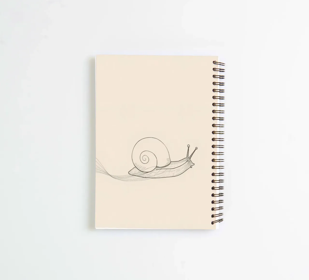 Snail glides gracefully across a smooth surface spiral notebook by DesignDoodle