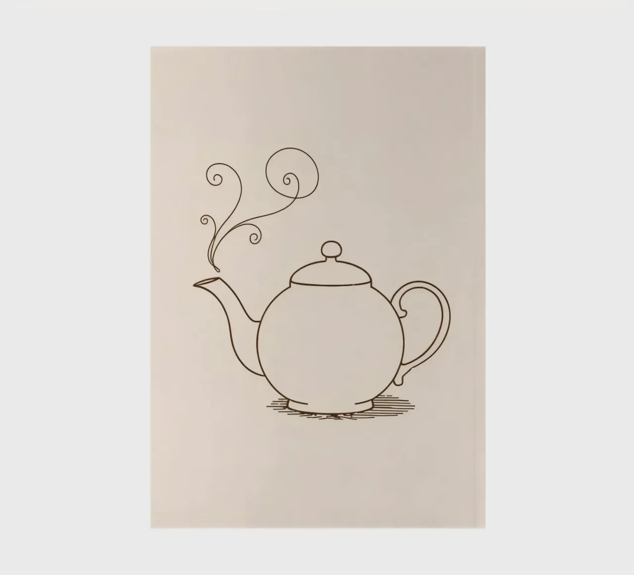 Elegant teapot with steam rising, showing a classic design notebook by DesignDoodle