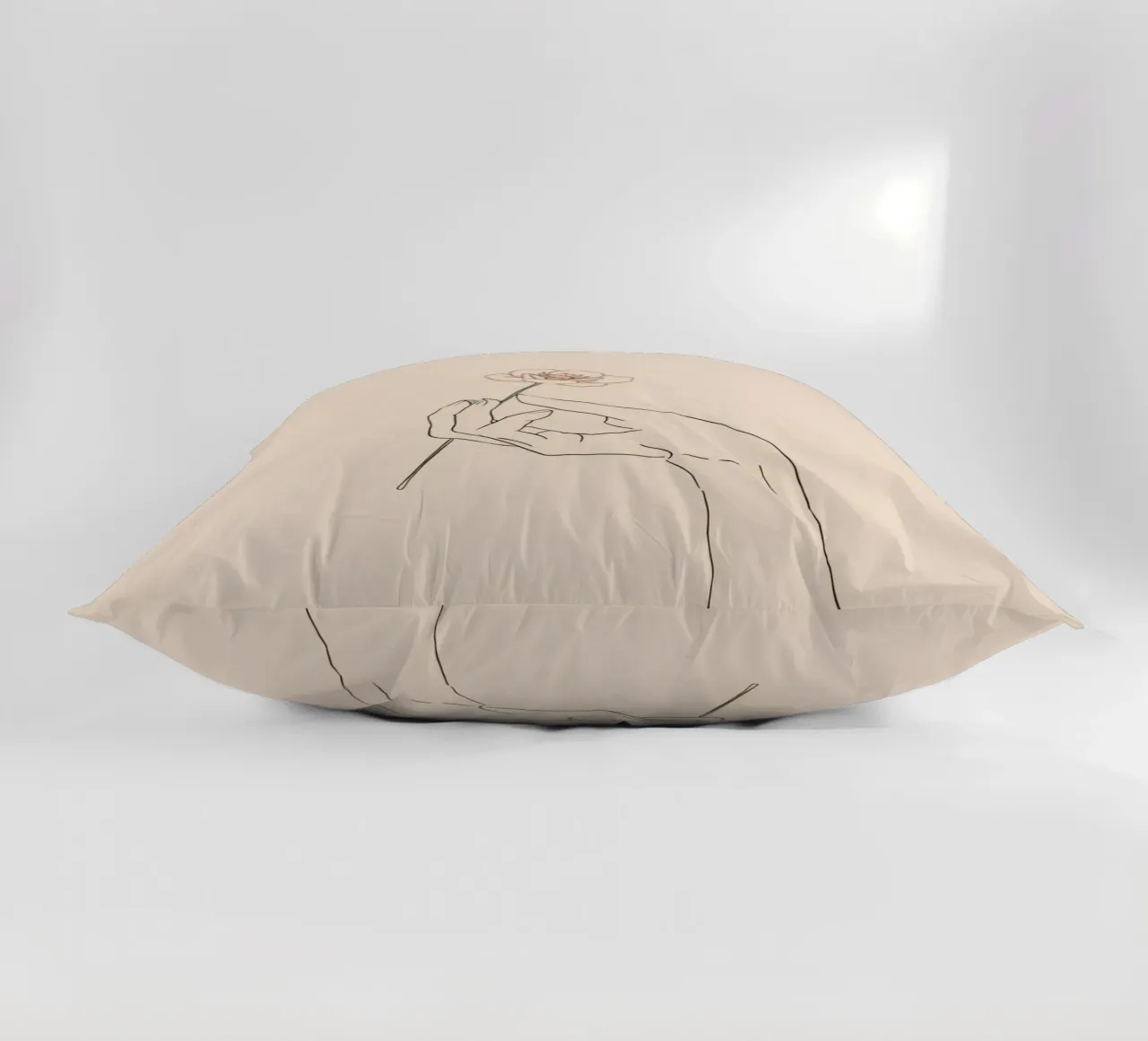 Elegant hand holding delicate flower against a soft beige decorative cushion by DesignDoodle