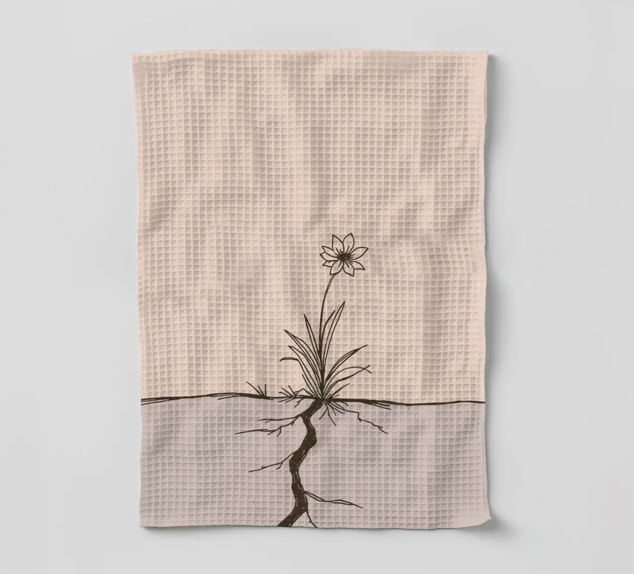 Fleur poussant à travers la terre craquelée dans un paysage désolé torchon de DesignDoodle