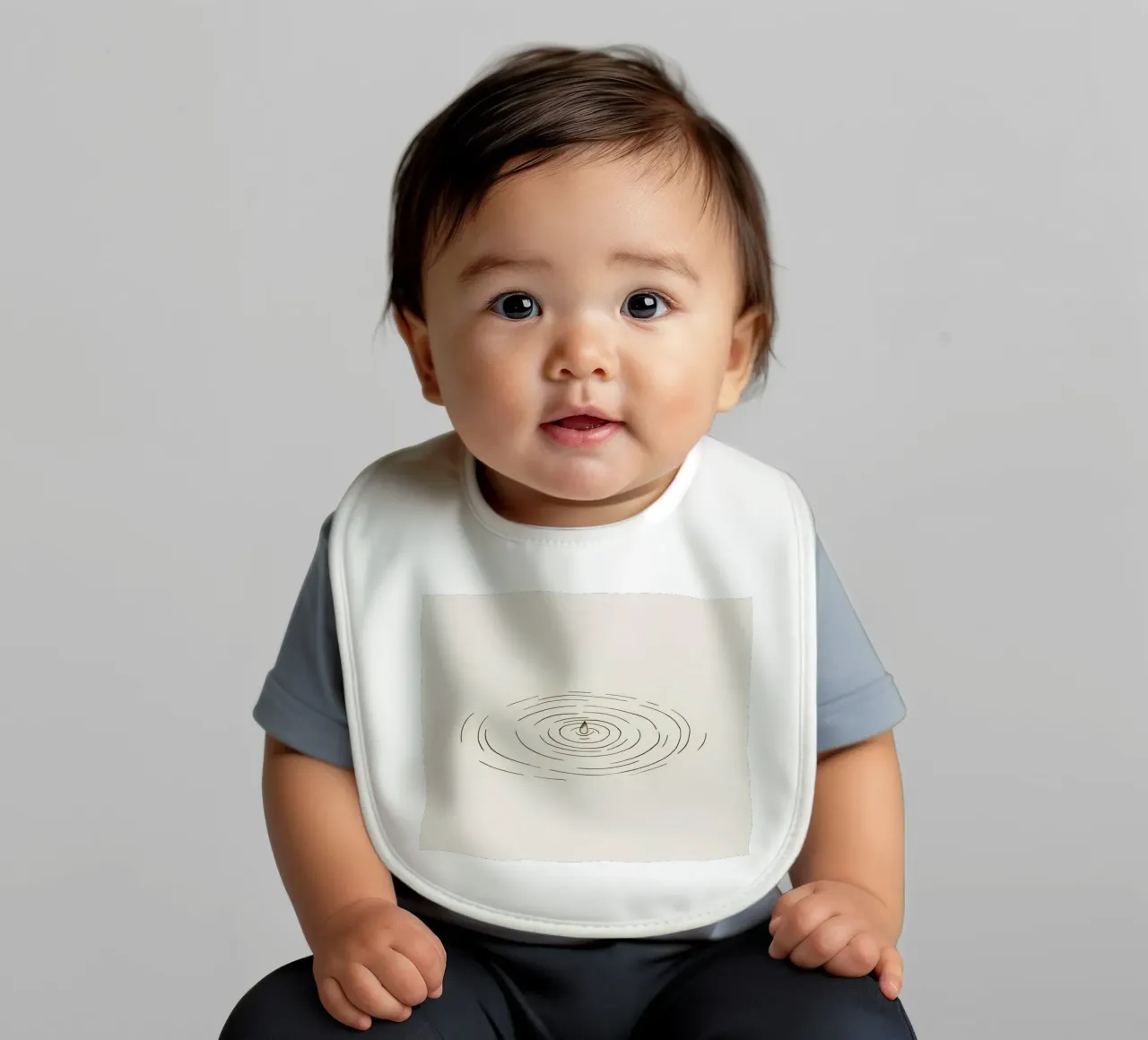 Ripples expanding in calm water created by a single drop baby bib by DesignDoodle