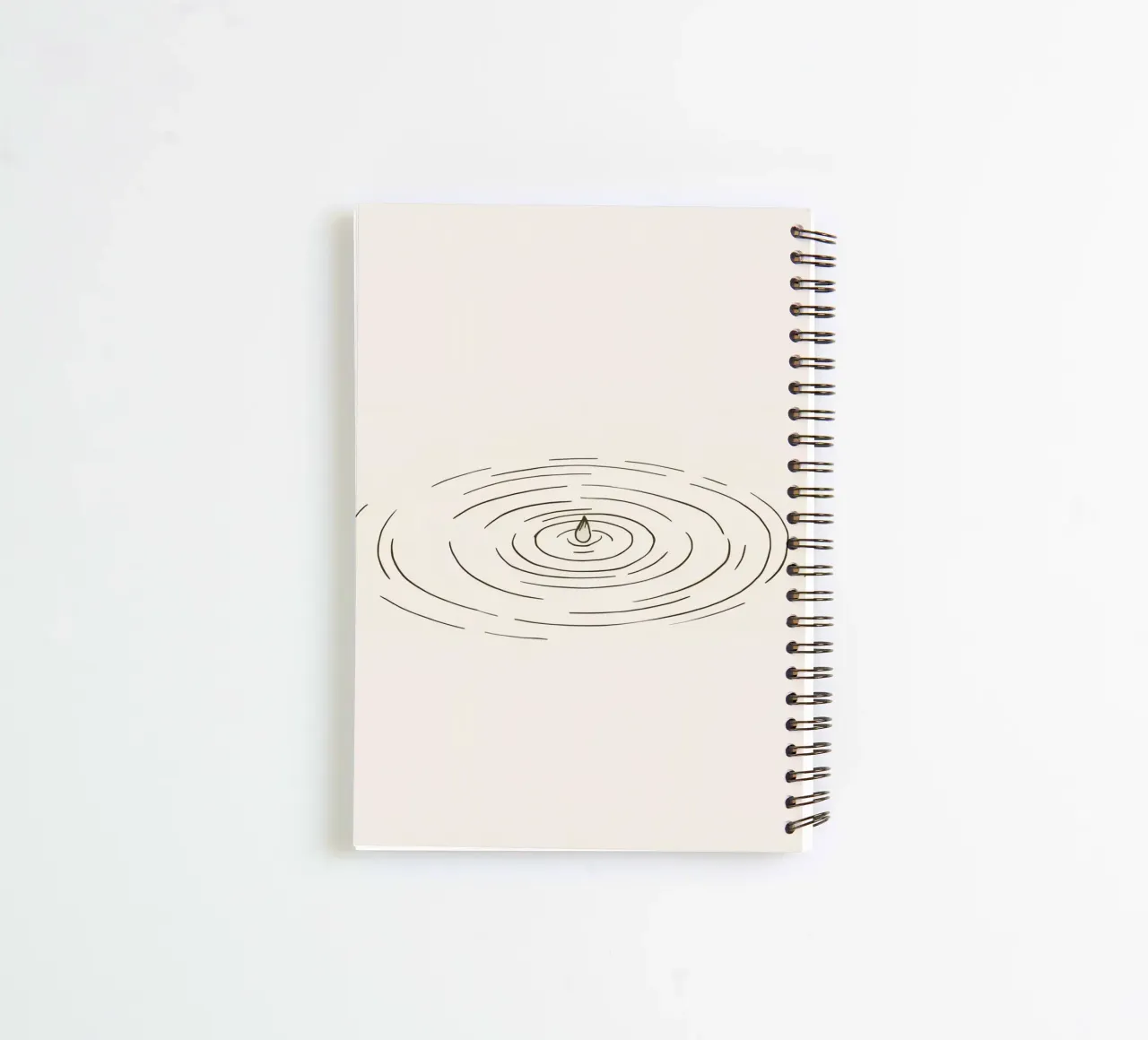 Ripples expanding in calm water created by a single drop spiral notebook by DesignDoodle
