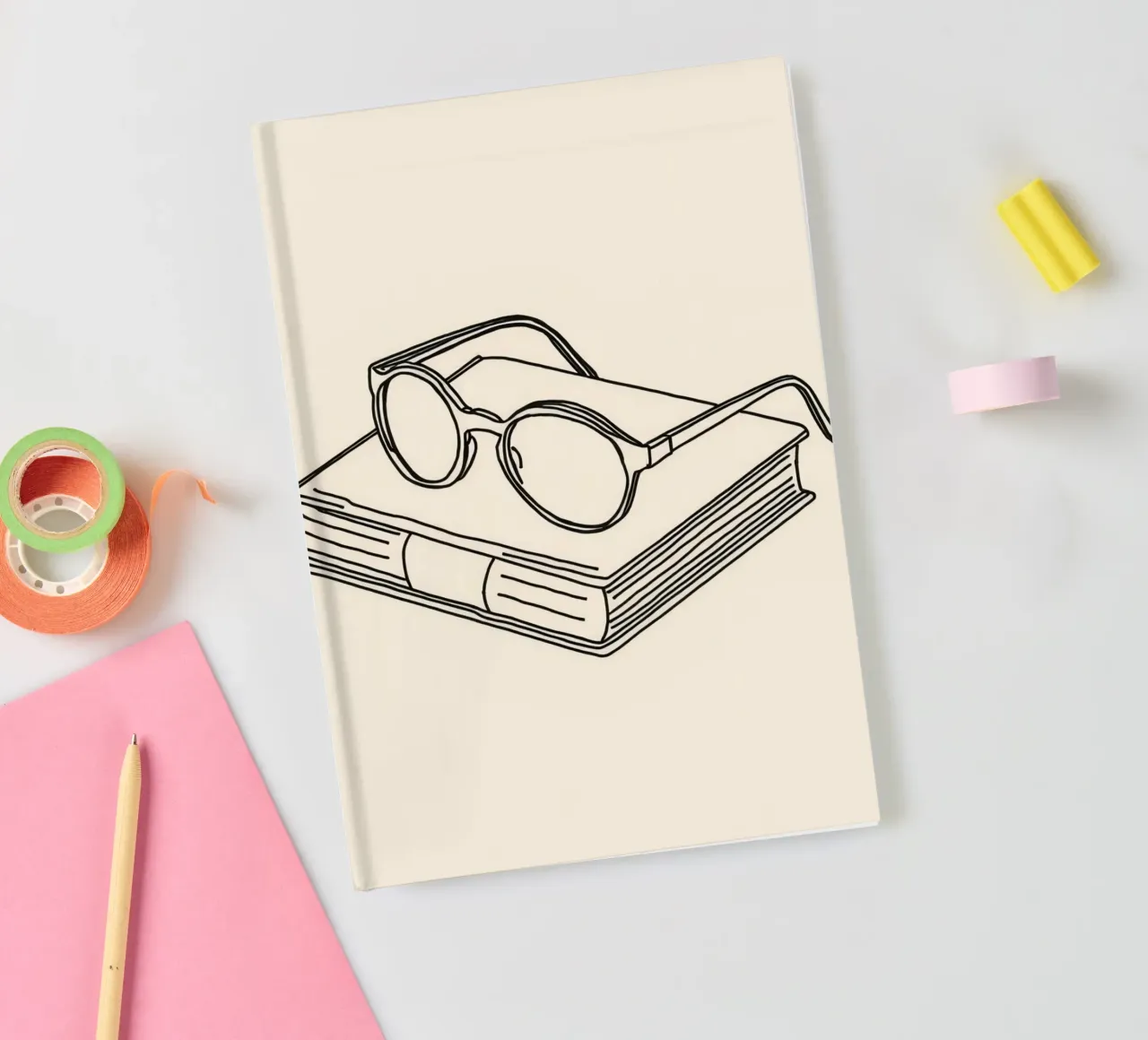 Glasses on a closed book symbolizing knowledge and reading notebook by DesignDoodle