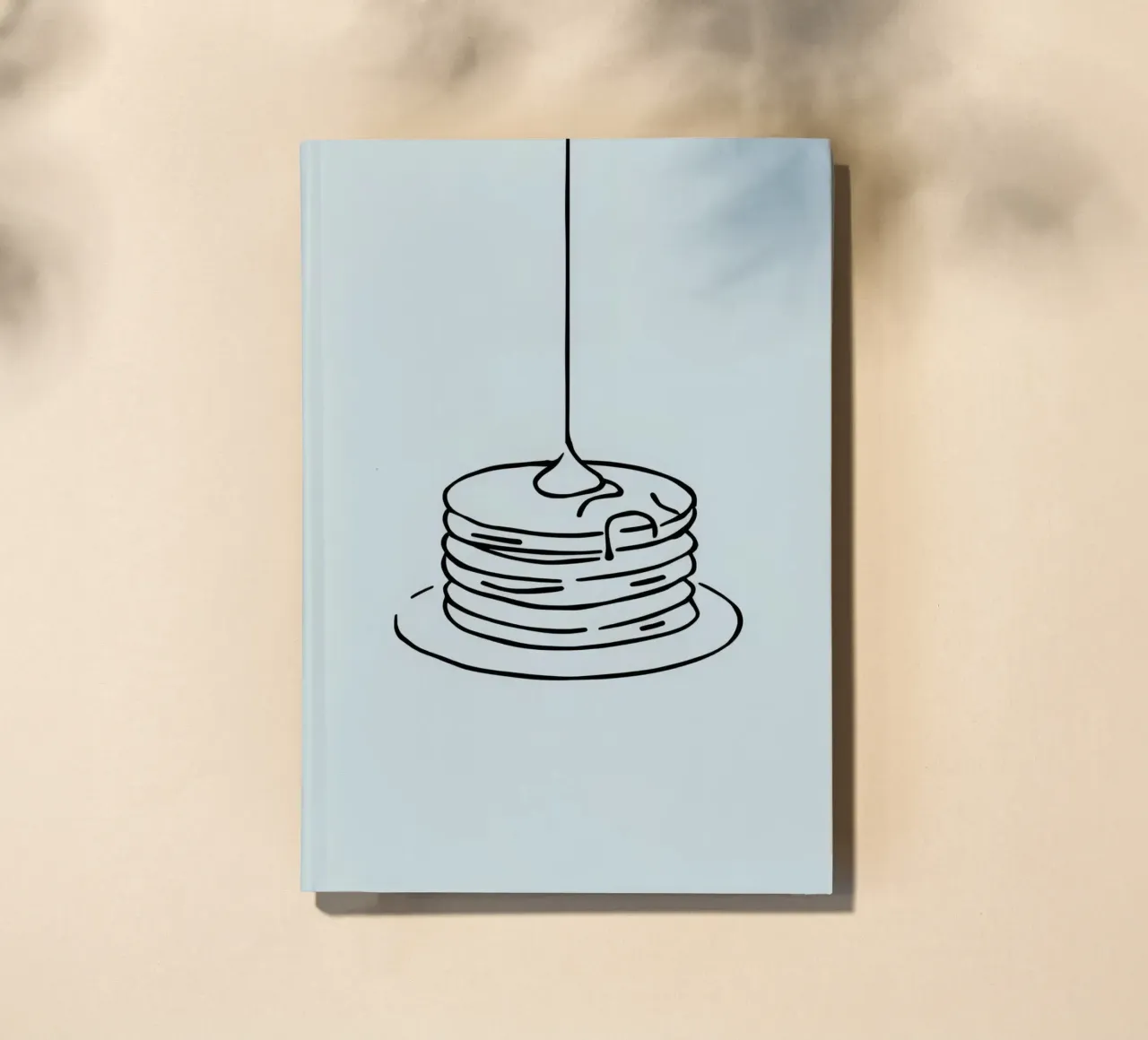 Stacked pancakes with syrup dripping on a green background notebook by DesignDoodle