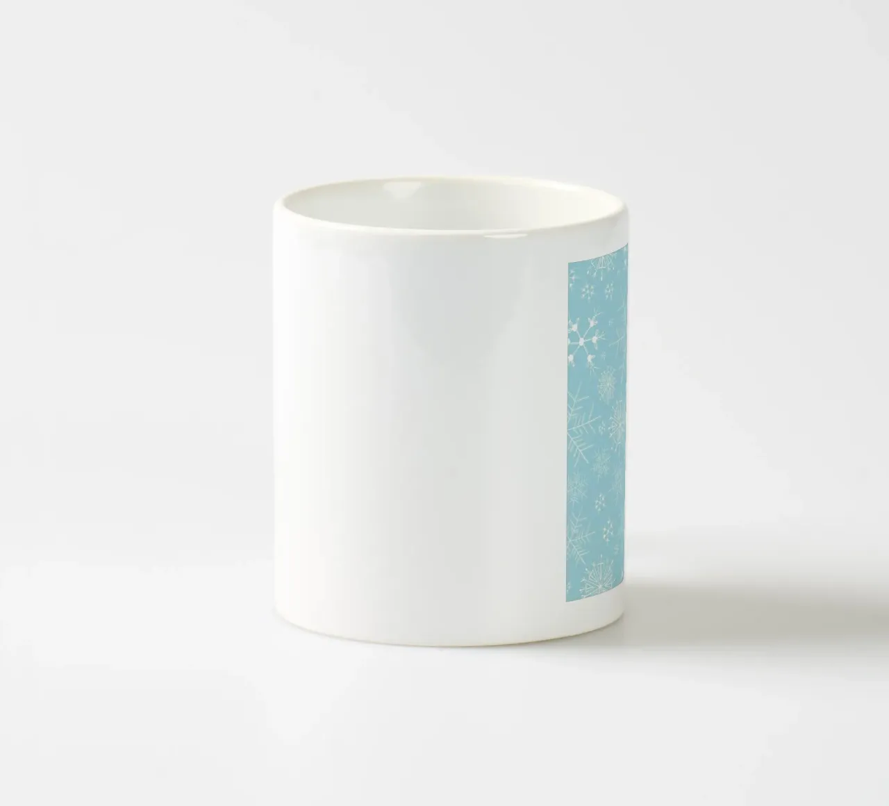 White snowflakes with blue background pattern ceramic mug by gulsengunel