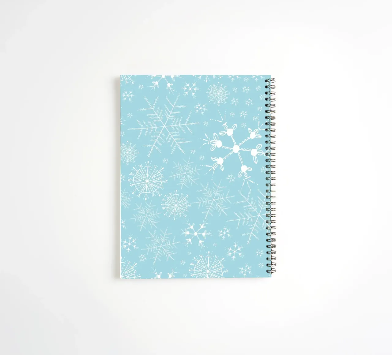 White snowflakes with blue background pattern spiral notebook by gulsengunel