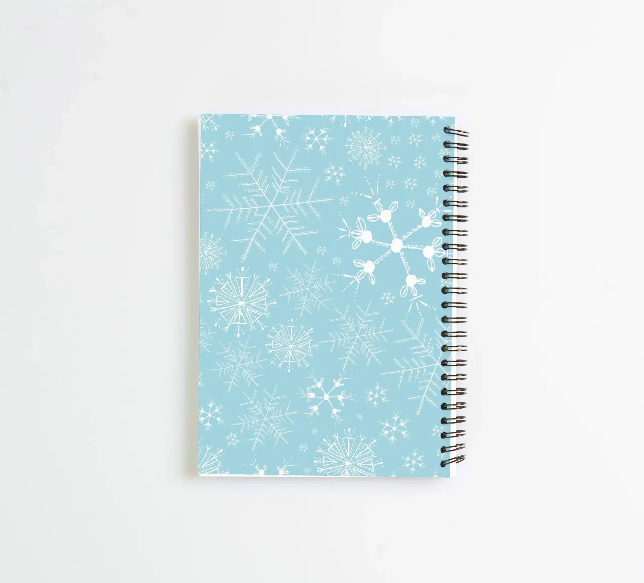 White snowflakes with blue background pattern spiral notebook by gulsengunel