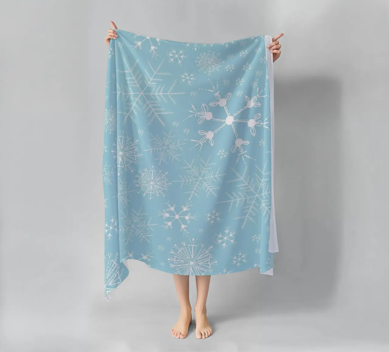 White snowflakes with blue background pattern beach towel by gulsengunel