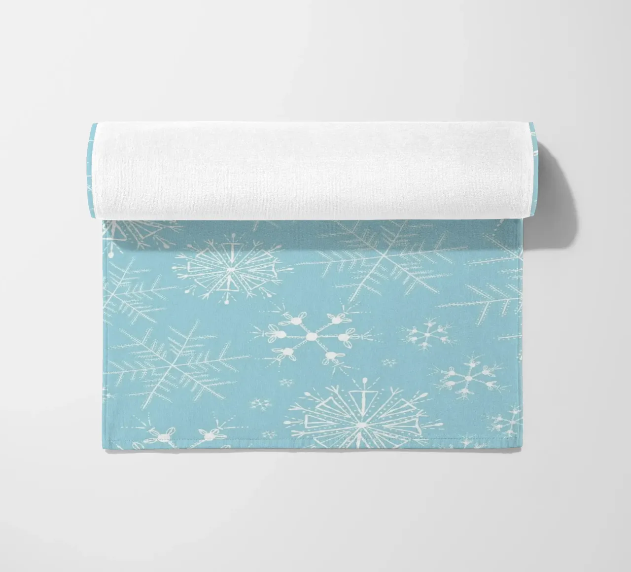 White snowflakes with blue background pattern beach towel by gulsengunel