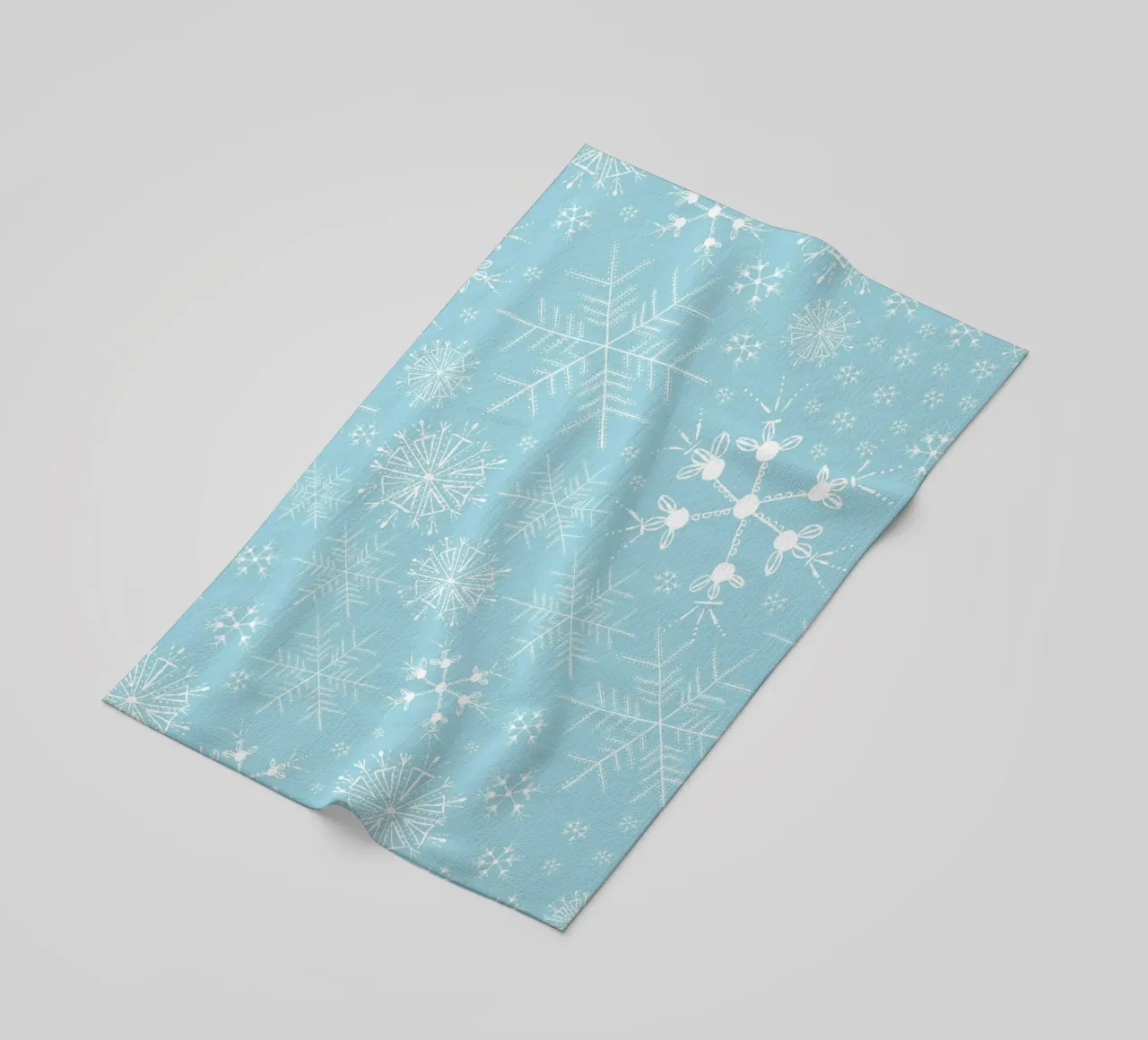 White snowflakes with blue background pattern beach towel by gulsengunel