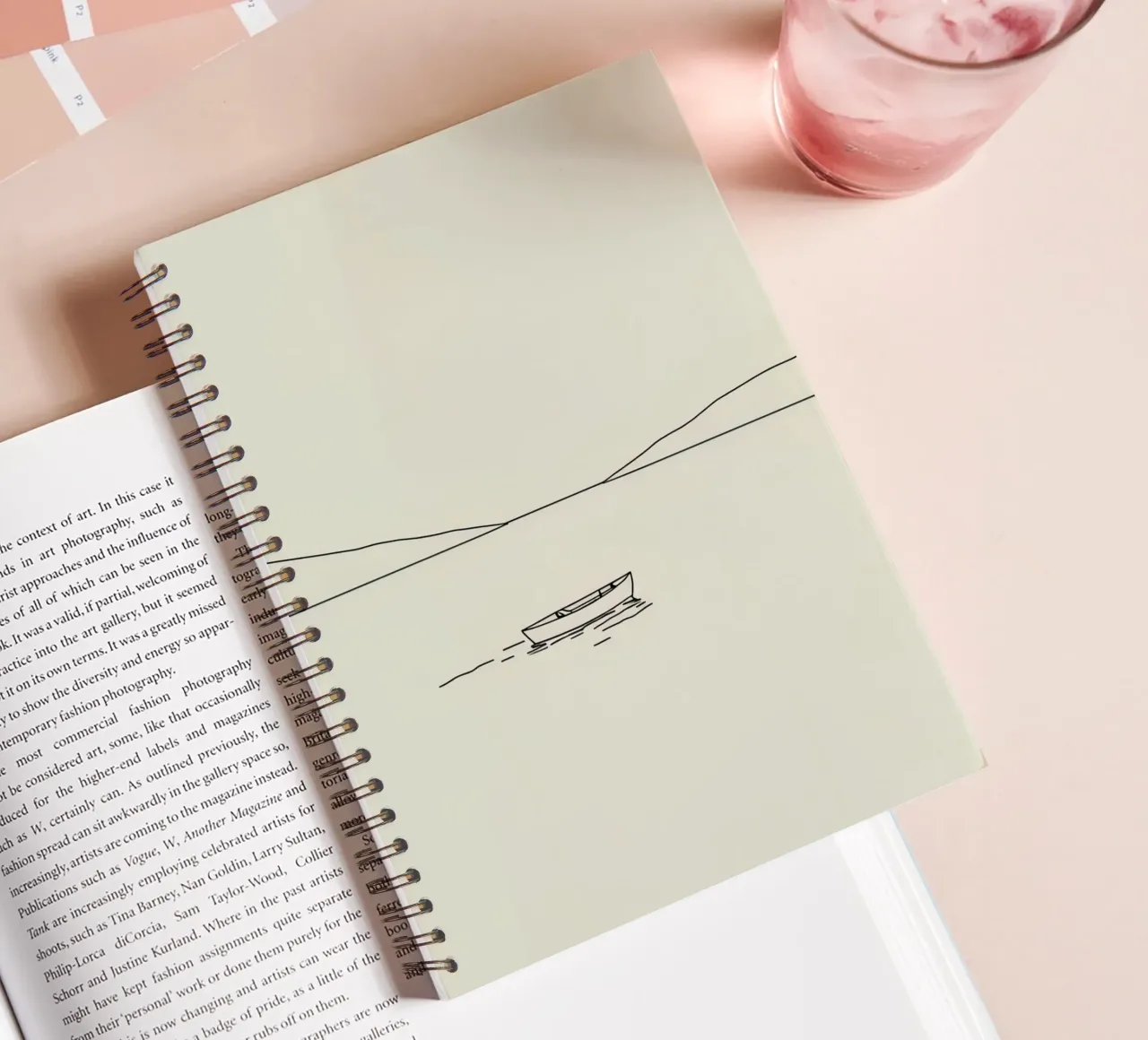 Calm waters reflect distant mountains with a lone boat float spiral notebook by DesignDoodle