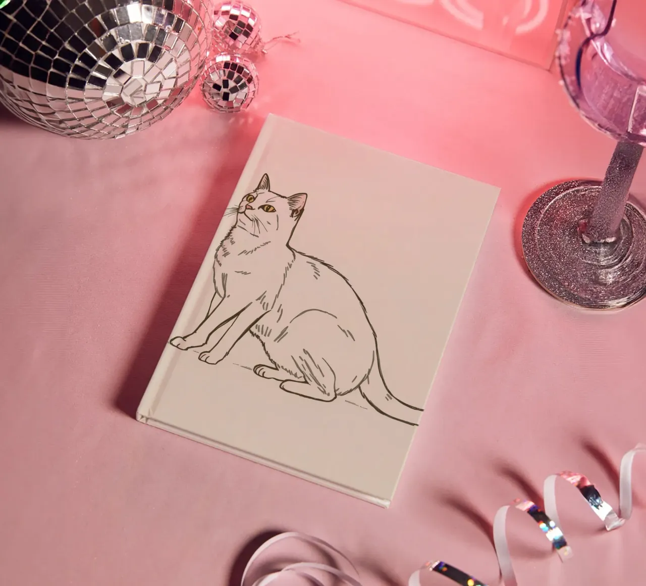 White cat sitting with alert expression in a minimalist art notebook by DesignDoodle