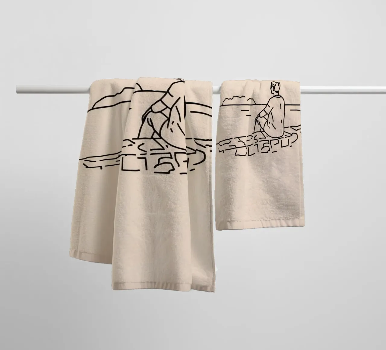 man reflects by the water while sitting on the shore towel by DesignDoodle